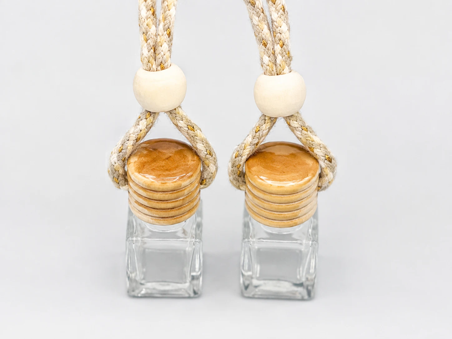Hanging glass car air freshener wooden caps after fragrance activation
